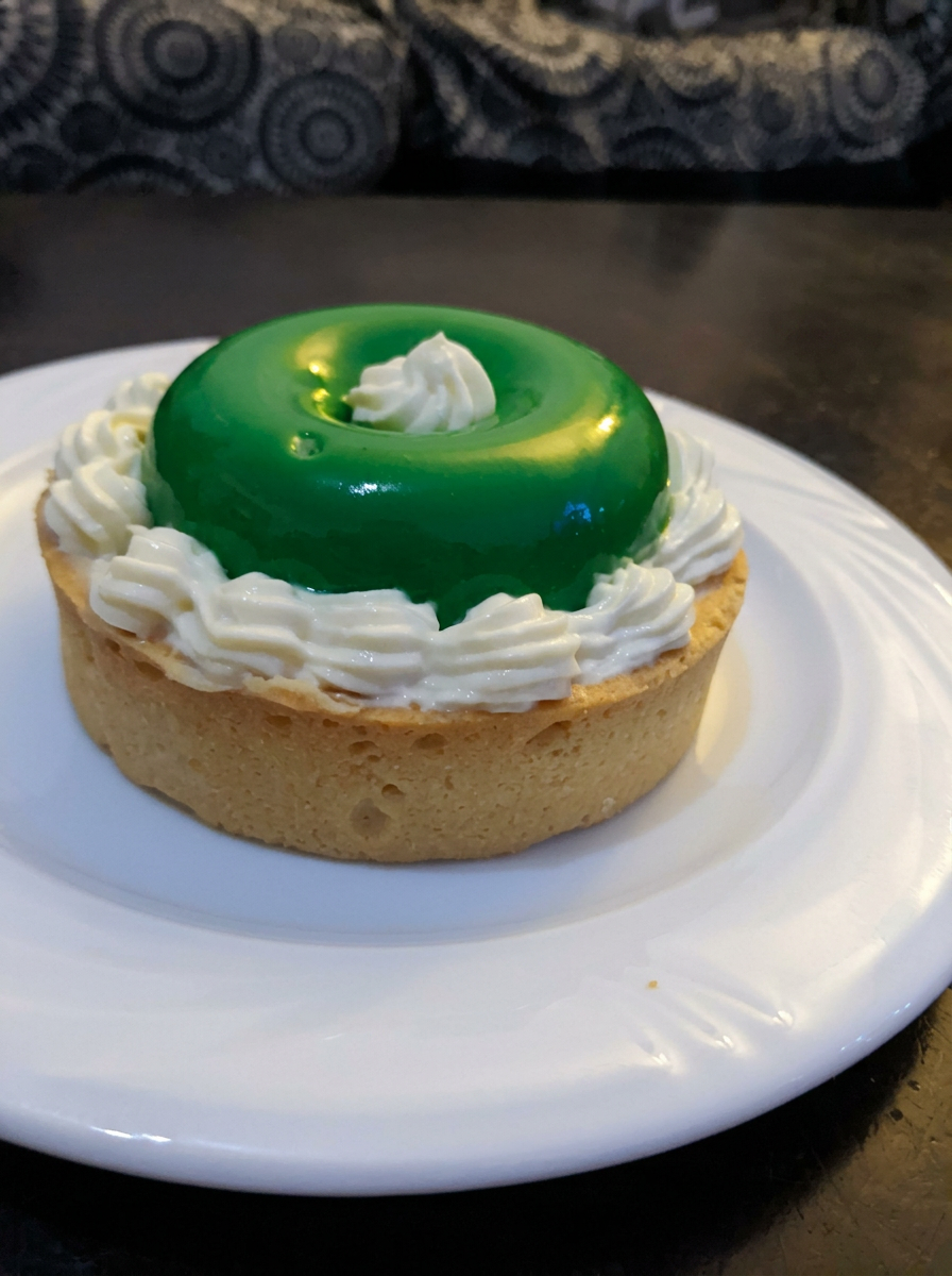 Pistachio glaze tart with piped cream